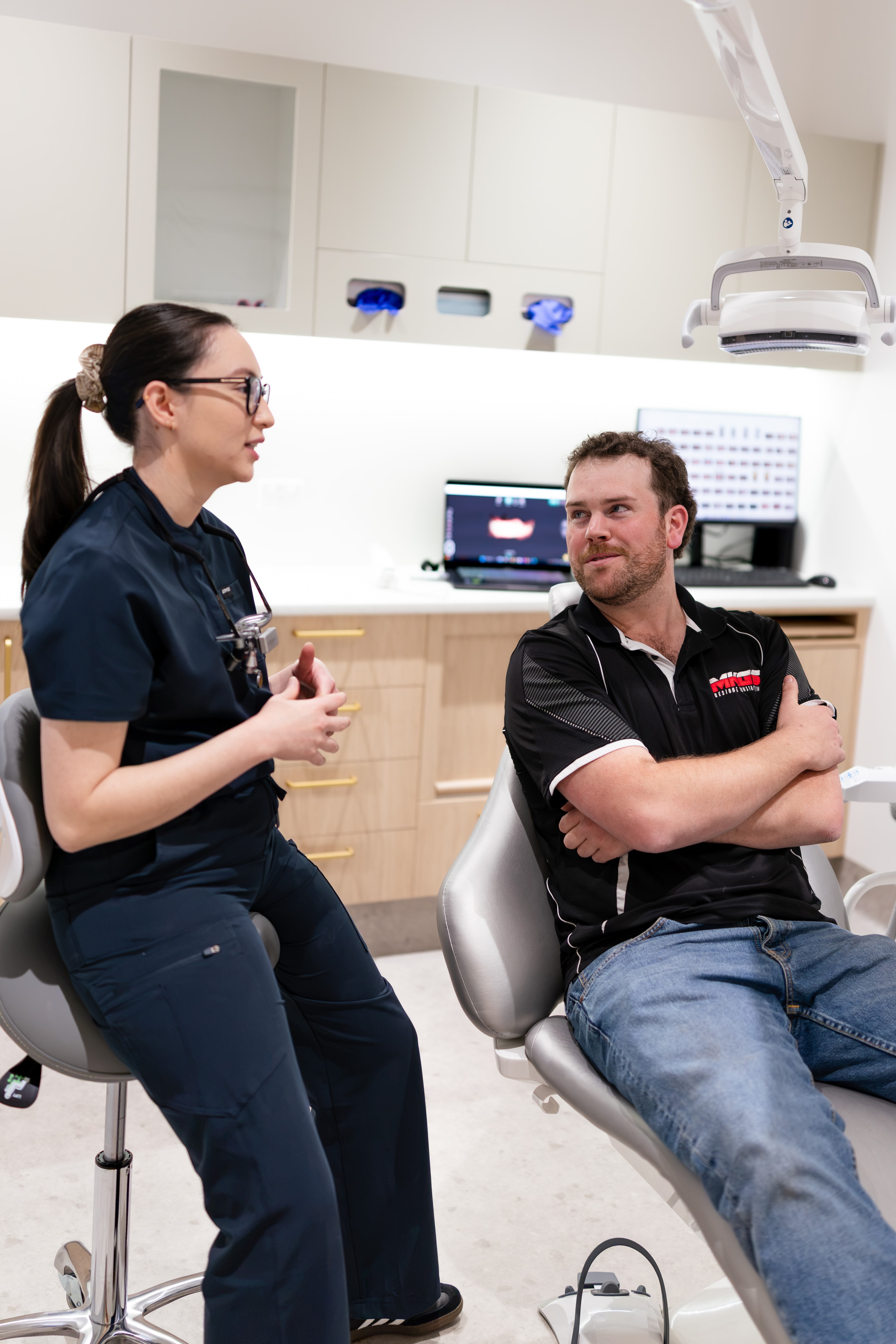 Patient reviewing cosmetic treatment goals in a hand mirror at Joyner Family Dental