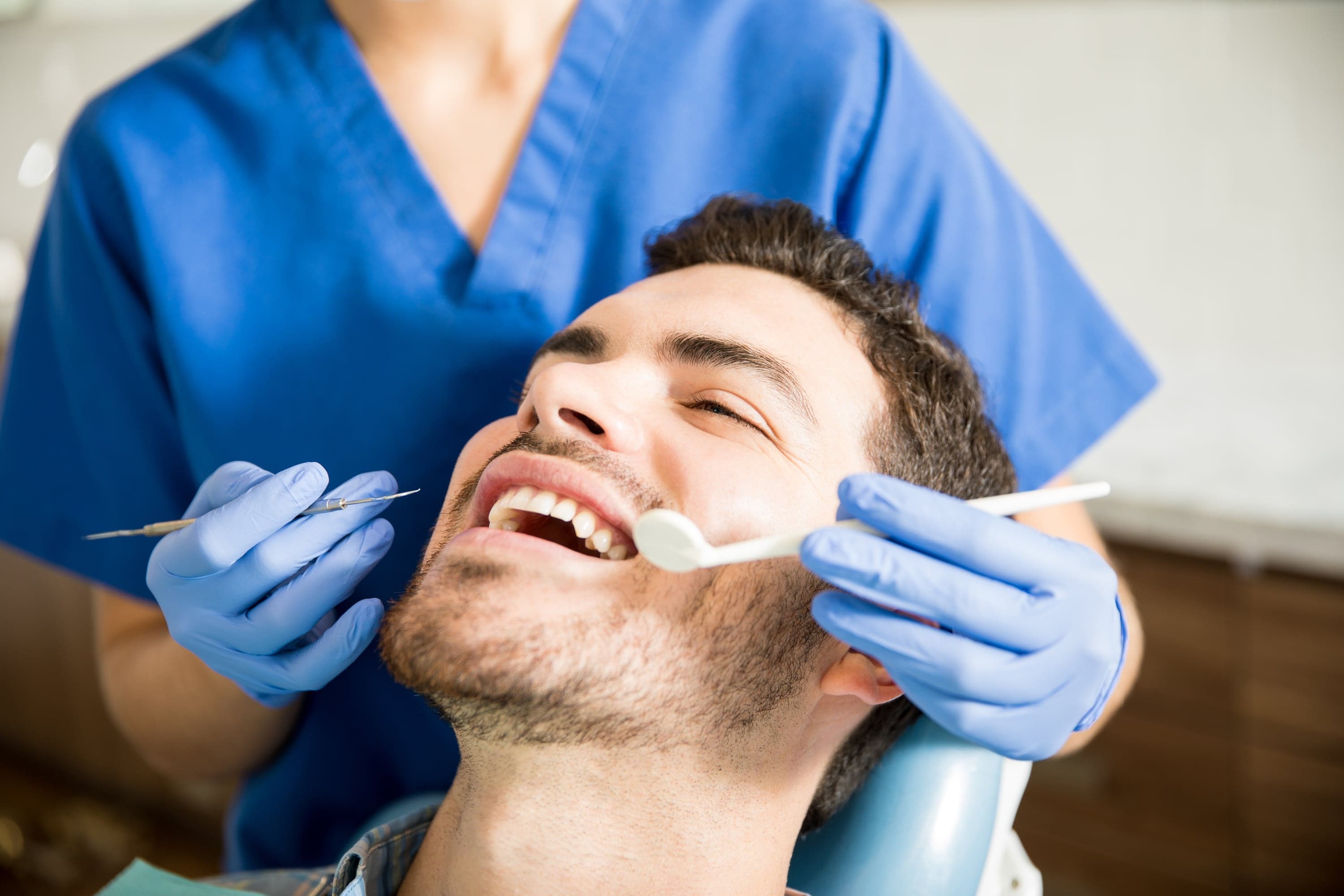 Dentist explaining gum care and maintenance options to a patient