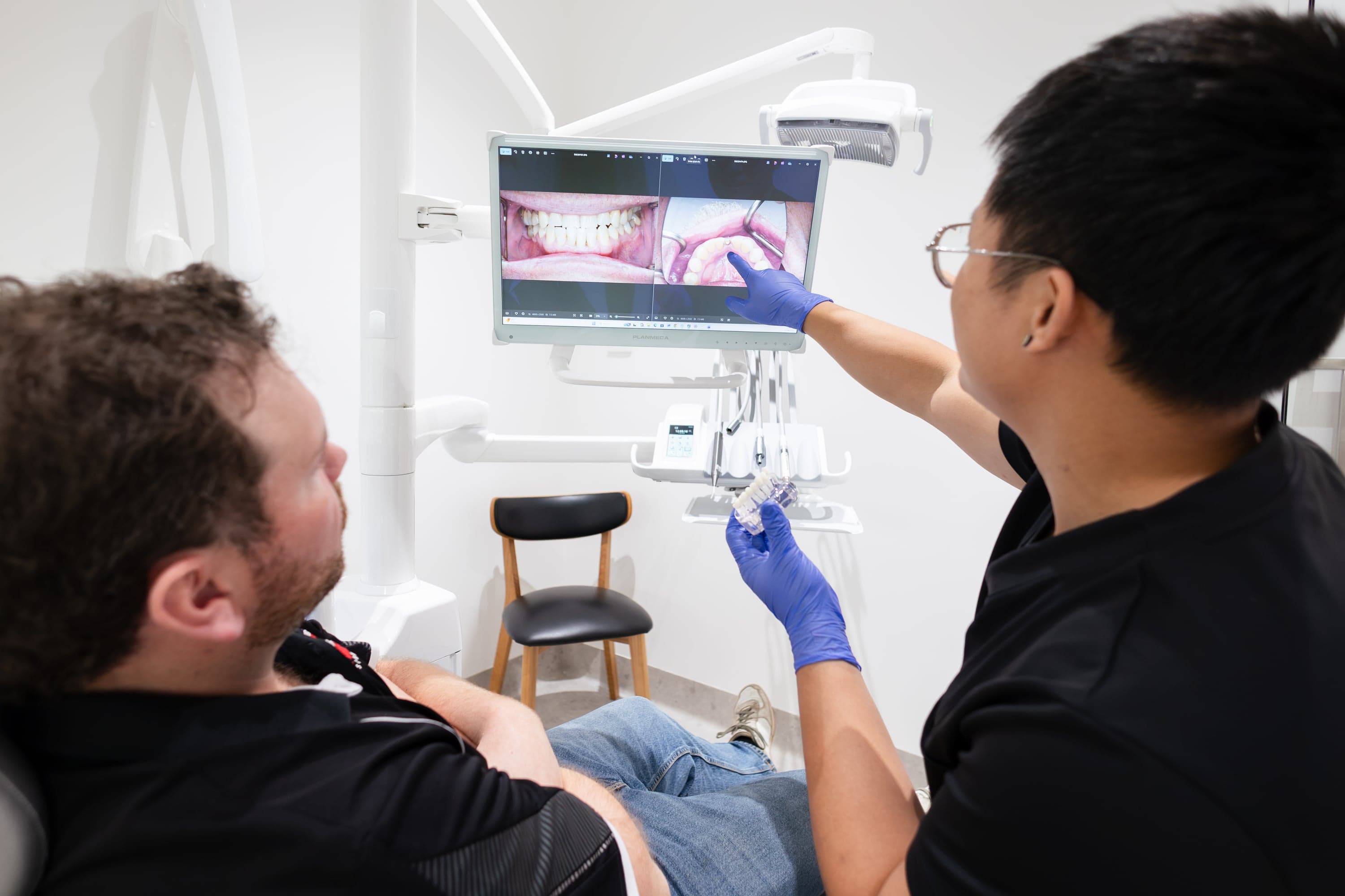 Dentist using dental technology during a patient consultation